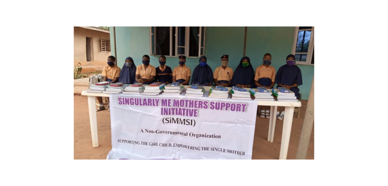 SiMMSI field work — girls with books in front of SiMMSI banner